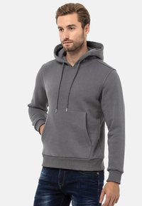 Grauer Hoodie aus weichem, strukturiertem Stoff, mit Kängurutasche, Kordelzugkapuze und gerippten Bündchen und Saum.