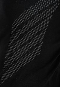 Tissu noir avec cinq rayures diagonales parallèles texturées grises formant un motif abstrait à travers la surface.