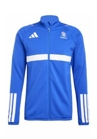 Veste zippée bleue avec des rayures blanches sur la poitrine et les manches. Possède le logo Adidas et l'emblème de la France sur le côté supérieur gauche.