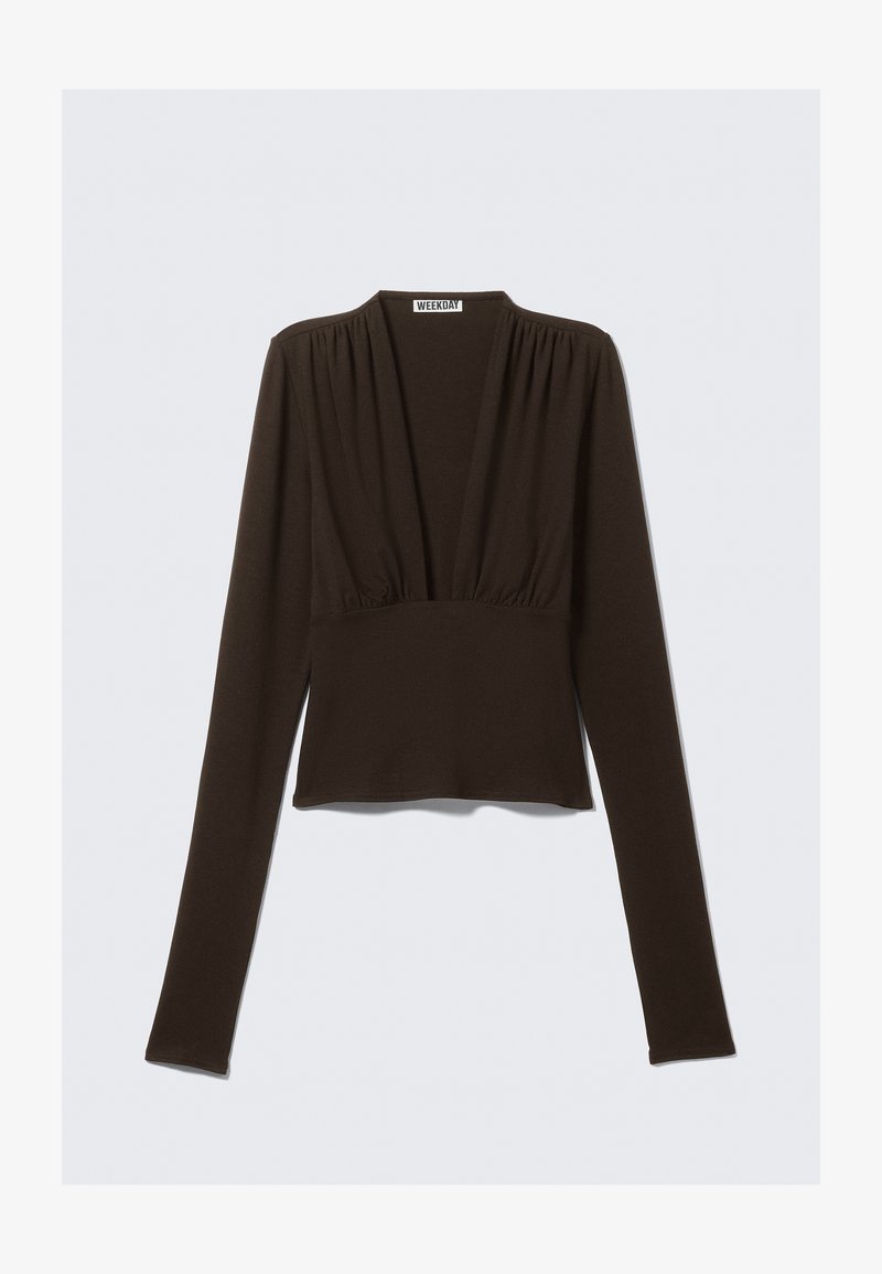 Bluza maro cu mâneci lungi, decolteu în V, cu detalii pliate pe umeri și talie mulată. Confecționată dintr-un material elastic pentru confort.