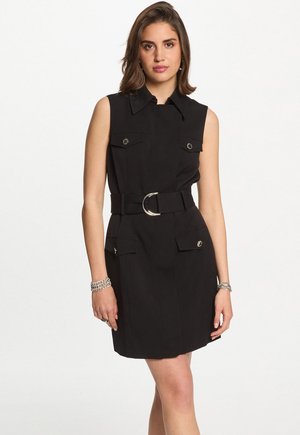 Black sleeveless dress with a collar, cinched waist belt featuring a silver buckle, and two front pockets with snap closures. Smooth texture.