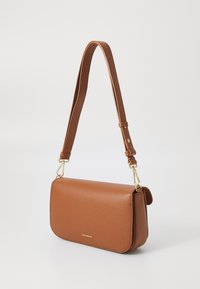 Brown leather crossbody bag with a textured finish, gold hardware, and a detachable, adjustable strap. Compact rectangular shape.