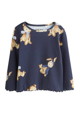 Navyblaues Langarmoberteil mit gerippter Textur, das ein Muster von Teddybären in verschiedenen Positionen zeigt. Mit einem gewellten Saumdetail.