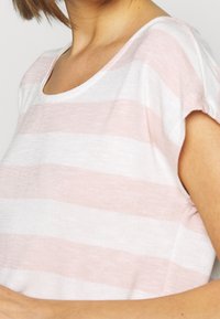 Lightweight, striped top featuring soft pink and white horizontal lines, a scoop neckline, and short sleeves. Smooth cotton texture.
