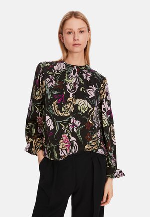 Schwarze Bluse mit floralem Muster in Pink, Grün und Creme. Sie verfügt über einen runden Halsausschnitt und lange Ärmel mit gerafften cuffs.