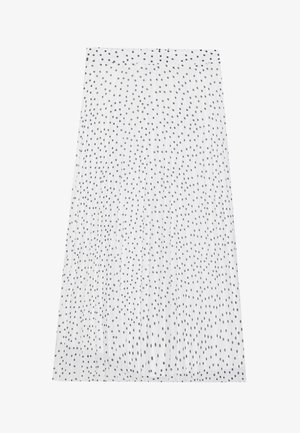 Jupe plissée blanche à pois noirs, avec une texture lisse et une taille élastique. La longueur descend sous le genou.