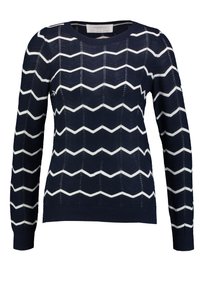 Pull en laine bleu marine avec motif en zigzag blanc, encolure ronde et manches longues. Présente des coutures texturées et un ourlet côtelé.