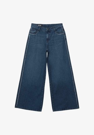 Dunkelblaue Jeans mit weitem Bein, silbernen Nieten, die die vorderen Taschen und Seitennaht umranden, Knopfverschluss und Gürtelschlaufen.