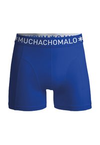 Zilā bokseru apakšbikses ar baltu jostu, uz kuras ar treknām burtām ir rakstīts zīmola nosaukums "MUCHACHO". Gluda auduma un pieguļošs dizains.