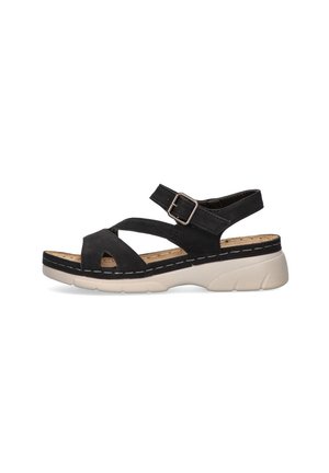 Sandalia negra con tirantes cruzados, hebilla ajustable, plantilla acolchada y parte superior texturizada en negro. Suela de goma blanca con patrón de relieve.