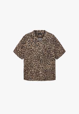 Lühikeste varrukatega nööpidega särk pruuni kangaga, millel on must leopardimuster. Omab klassikalist kraed ja taskut vasakul küljel.