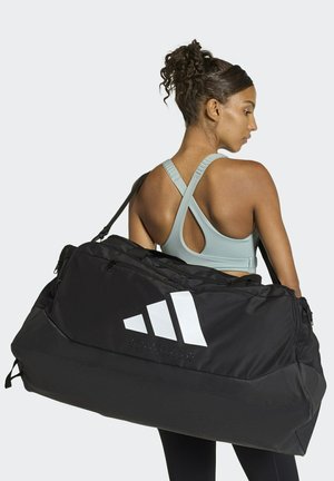 Sort sportstaske med hvidt Adidas-logo, holdbart stof, stor kapacitet, dobbelt håndtag og rummeligt hovedrum.