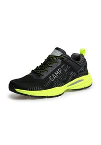 Black athletic shoe with textured mesh upper, neon yellow accents, grey branding on tongue, and black rubber sole with traction pattern.