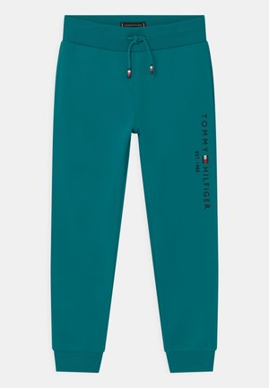 Morsko-zielone spodnie dresowe ze ściągaczem, z prążkowanymi mankietami i pasem, z pionowym napisem "Tommy Hilfiger Est. 1985" oraz logo na prawej nogawce.