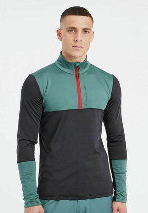 Men’s long-sleeve top in green and black, featuring a high collar, quarter zip with red accent, and contrasting sleeve cuffs.