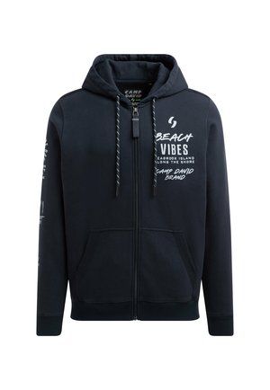 Navy blue zip-up hoodie with front pockets, drawstring hood, and white text reading "Beach Vibes" and "Camp David Brand" on chest and sleeves.