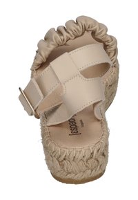 Beige sandal with a textured, woven espadrille sole, a smooth leather upper, and a gathered elastic accent at the heel. Features a metal buckle.