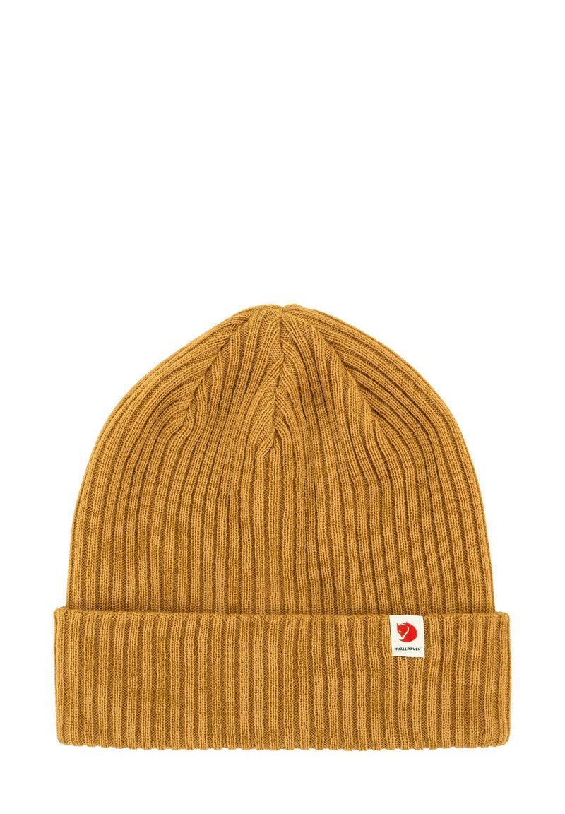 Mustard yellow knit beanie with a ribbed texture and folded cuff. Features a small red and white brand logo tag on the side.