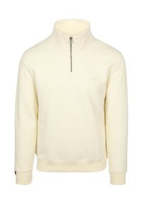 Cream-colored pullover sweatshirt, half zip, with a high collar. Features ribbed cuffs and hem, made from soft fabric, minimal branding.