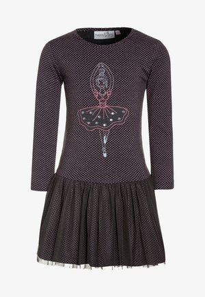 Zwarte jurk met lange mouwen en roze stippen, voorzien van een ballerina-afbeelding en een tule ruches aan de onderrand. Gemaakt van zachte stof.