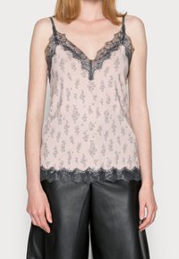 Lace-trimmed camisole in pale pink, featuring a floral pattern and a deep V-neck design, with grey lace accents along neckline and hem.