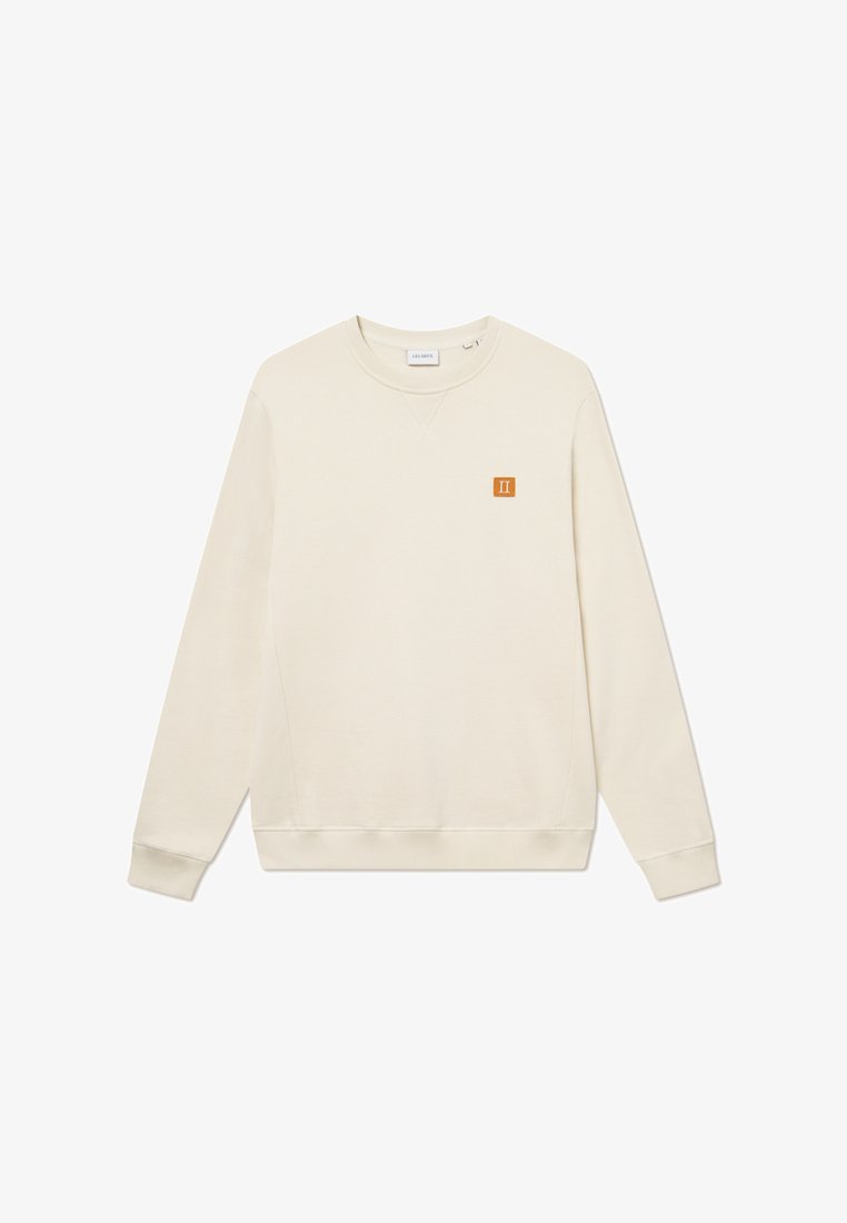 Light beige sweatshirt made of soft fabric. Features a crew neck and long sleeves. Includes a small orange logo on the chest.