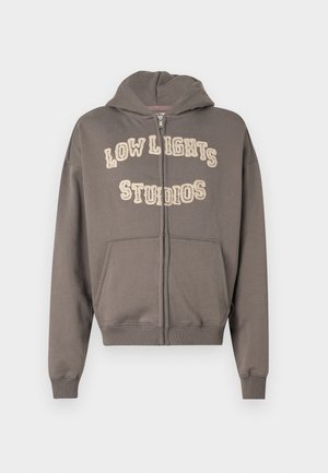 Gray zip-up hoodie with spacious front pockets, a hood, and "LOW LIGHTS STUDIOS" printed in light-colored, textured lettering on the chest.