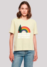 Light yellow cotton t-shirt featuring a colorful rainbow graphic with a pine tree and the text "DESTROY THE PATRIARCHY NOT THE PLANET."