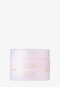 Huxley huidverzorgingscrème in een matte lavendelkleurige jar met een witte deksel. Bevat gouden tekst met details over ingrediënten en de productnaam.