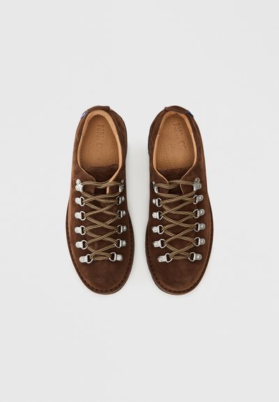 Brown suede shoes with a rounded toe, featuring silver-tone hardware and lightweight laces for enhanced grip and styling.