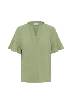 Blouse à manches courtes texturée vert clair avec un col rond et une encoche en V à l’avant.