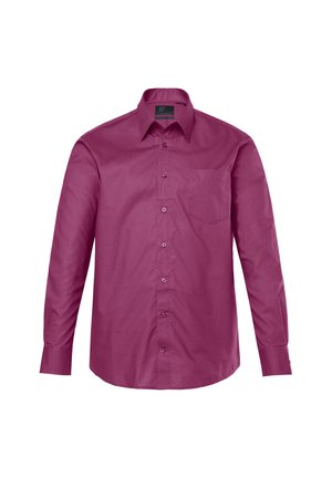 Košile s dlouhým rukávem v tmavě měděné látce, vybavená špičatým límcem, předními knoflíky a kapsou na hrudi. Hladká textura s přiléhavým střihem.