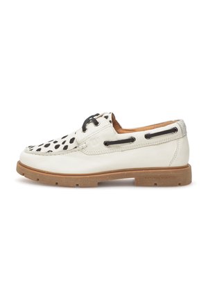 White leather boat shoe with black polka dot pattern on the front, round toe, black laces, and a textured rubber sole.