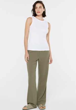 White sleeveless top with a round neckline paired with olive green wide-leg pants. The top has a ribbed texture, and the pants are smooth.