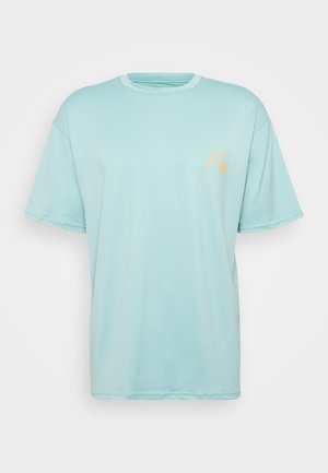 Light blue short-sleeve t-shirt with a round neckline. Features a small orange logo on the left chest area. Made from soft cotton material.
