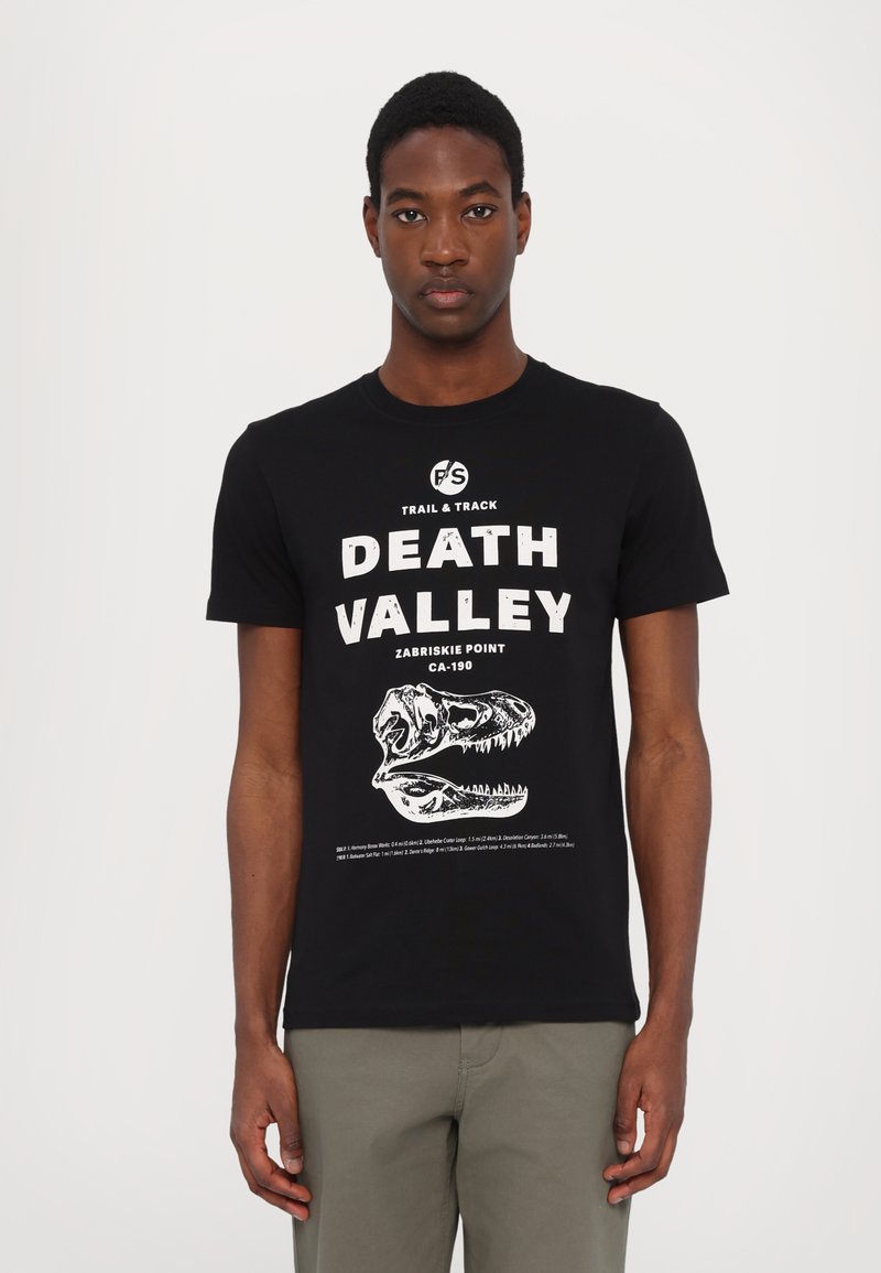 Czarna bawełniana koszulka z białą grafiką przedstawiającą tekst "DEATH VALLEY" oraz projekt czaszki dinozaura. Klasyczny okrągły dekolt i krótkie rękawy.
