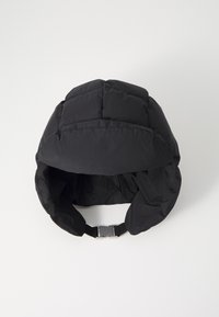 Black padded hat with a rounded shape, featuring a chin strap and smooth texture. The design includes stitch detailing for added structure.