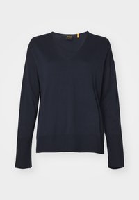 Granatowy sweter z długim rękawem i dekoltem w serek, z prążkowanymi mankietami i dołem, wyeksponowany na jednolitym jasnym tle.