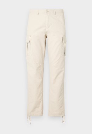 Beige kottongri bööditsid, mis on valmistatud puuvilla segakangast. Omadusteks on kaks küljetaskut, sirged säärte disain ja reguleeritavad paelad ääred.