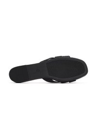 Sandal negra con parte superior texturizada, correas ajustables y suela plana de goma con detalles acanalados para mayor agarre.