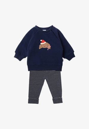 Navy sweatshirt with croissant graphic wearing a Santa hat, paired with black and white striped leggings. Soft fabric, ribbed cuffs.