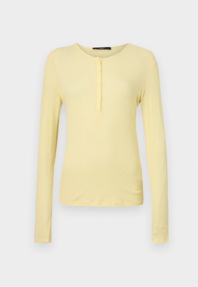 Long-sleeve, ribbed T-shirt in light yellow with a rounded neckline and five-button placket. Soft texture with a slim fit.