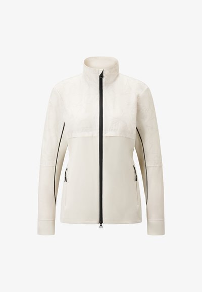 Helle beige Jacke mit hohem Kragen, Reißverschluss vorne und seitlichen Taschen. Sie verfügt über ein strukturiertes Muster im oberen Bereich und schwarze Akzente.