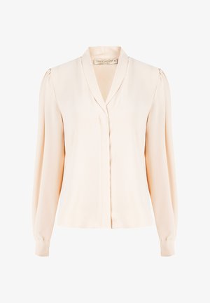 Blusa lunga a maniche con scollo a V di colore rosa pallido, con una trama morbida, spalle plissettate e una patta frontale, realizzata in morbido tessuto di seta leggera.
