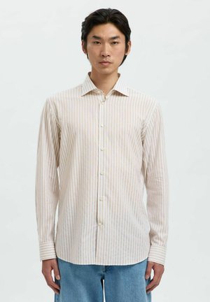 Light-colored long-sleeved shirt with thin vertical stripes in cream and pastel hues, featuring a pointed collar and button-down front.
