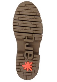Brown rubber shoe sole with a textured, patterned tread and a prominent red star logo. Features deep grooves for traction.