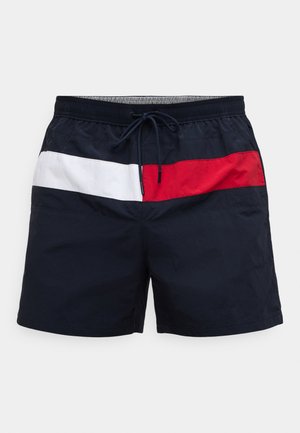 Marineblauwe zwemshorts met elastische tailleband, witte en rode horizontale strepen aan de voorkant, en een trekkoord voor een verstelbare pasvorm.