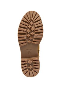 Suela de zapato Geox con una superficie de goma con patrón en tono beige, que presenta ranuras multidireccionales y un logo central para mayor agarre y soporte.