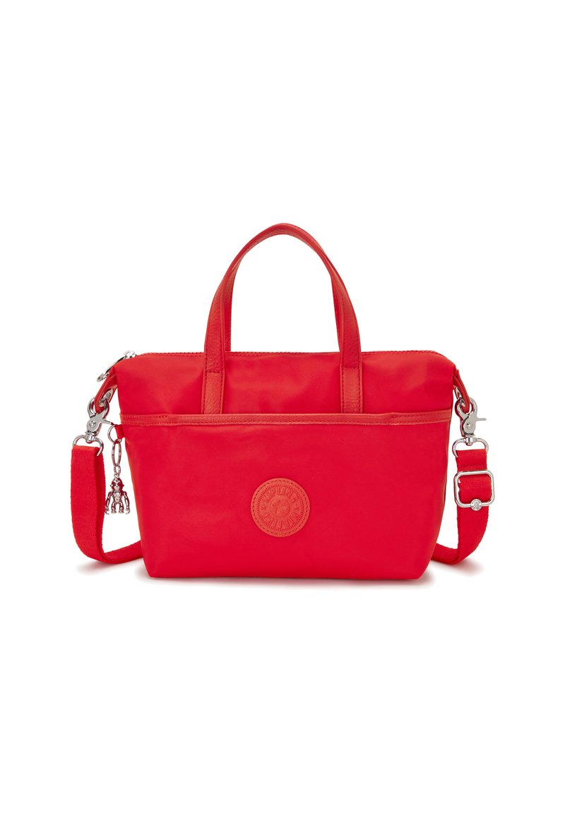 Red nylon handbag with dual top handles, detachable shoulder strap, and embossed logo patch. Smooth texture with zip closure and front pocket.