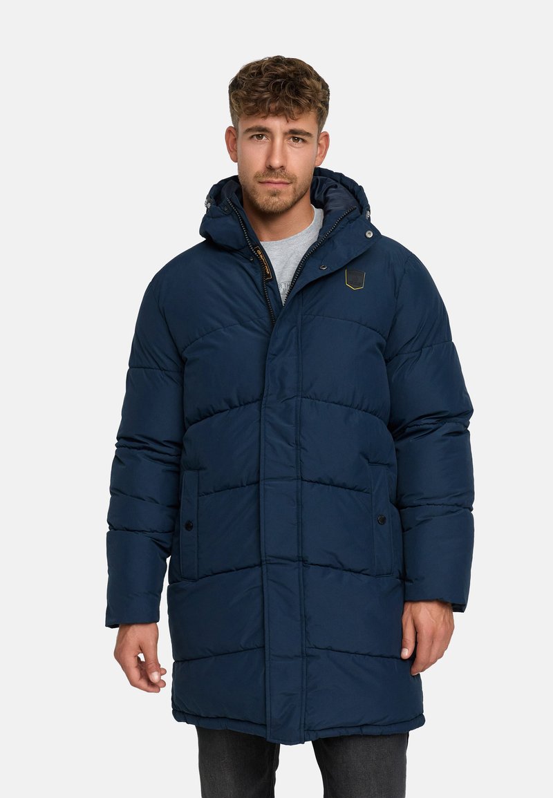 Navy blue puffer coat with a hood, featuring a quilted design, front pockets, and a zipper closure, made of insulating material.